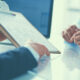 Businesspeople sitting on the desk in office